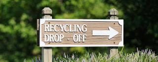 sign that says Recycling Dorp Off with directional arrow